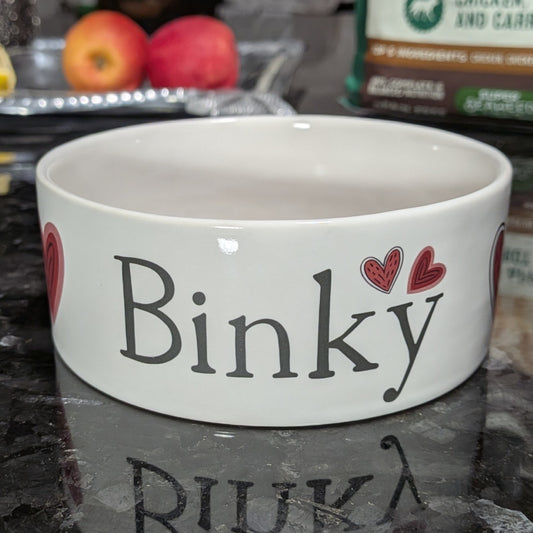 White personalized dog bowl with valentine's red hearts.