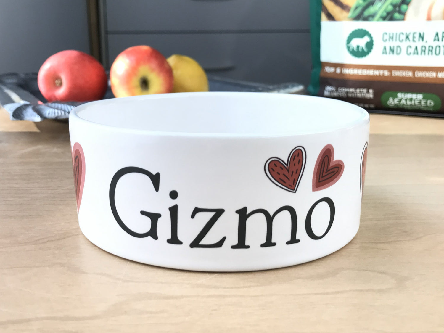 White personalized dog bowl with red valentine's hearts.