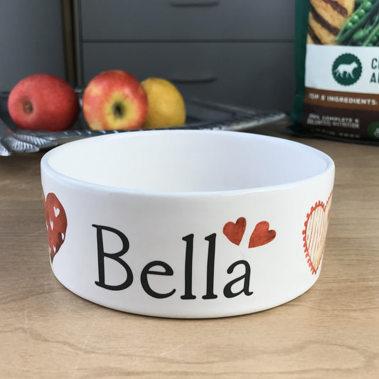 White personalized dog bowl with images of red watercolor hearts.