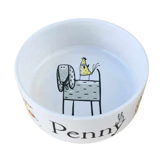 White personalized dog bowl with funny cartoon image in the center of the bowl of dog with a rooster on his back.