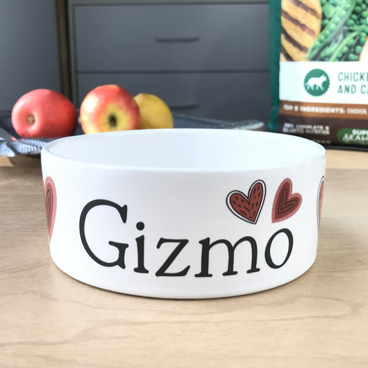 White personalized dog bowl with red valentine hearts.